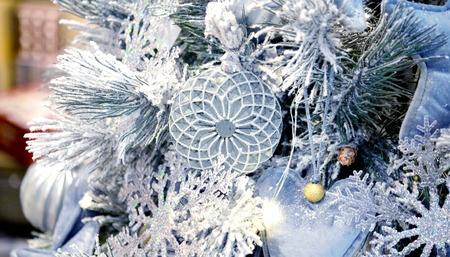 Decorative snow-covered Christmas tree decorated with decorative Christmas-tree toys gray hearts from fabric, glass Christmas trees tous, snowflakes, decorations. Christmas Winter New Year background.の写真素材