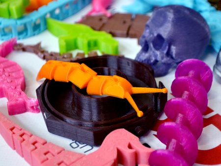 Models printed by 3d printer. Bright colorful objects printed on a 3d printer on a table close-up....
