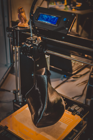 3D printer printing a model in the form of black vase close-up. The concept modern additive technology. The 4ht industrial revolution.の写真素材
