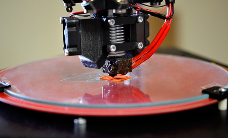 Modern 3D printer printing figure close-up macro. Automatic three dimensional 3d printer performs plastic modeling in laboratory. 3d-printing processing with white backgroundの写真素材