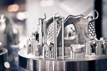 Object printed on metal 3d printer close-up. Object printed in laser sintering machine. Modern 3D...
