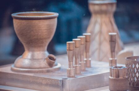 Man is holding object printed on metal 3d printer. Object printed in laser sintering machine. Modern 3D printer printing from metal powder. Progressive additive DMLS, SLM, SLS 3d printing technologyの写真素材