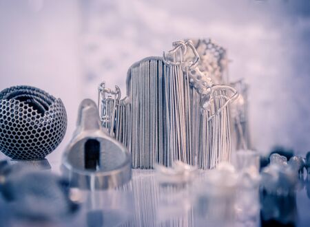 Object printed from metal powder on metal 3d printer.Object printed in laser sintering machine. Modern 3D printer printing from metal powder. Progressive additive DMLS, SLM, SLS 3d printing technologyの写真素材
