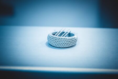 Object printed from metal powder on metal 3d printer.Object printed in laser sintering machine. Modern 3D printer printing from metal powder. Progressive additive DMLS, SLM, SLS 3d printing technologyの写真素材