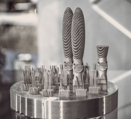 Object printed on metal 3d printer close-up. Object printed in laser sintering machine. Modern 3D...