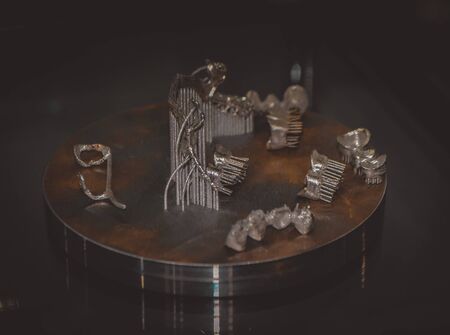 Object printed on metal 3d printer close-up. Object printed in laser sintering machine. Modern 3D printer printing from metal powder. Concept progressive additive DMLS, SLM, SLS 3d printing technologyの写真素材