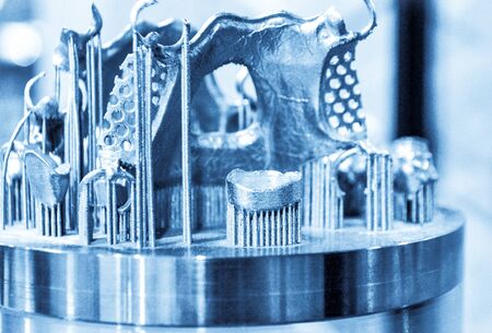 Object printed on metal 3d printer close-up. Object printed in laser sintering machine. Modern 3D...