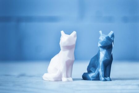 Two object of green yellow color printed 3d printer is stands on yellow table on background of gray blue brick wall close-up. Concept progressive modern additive technology for 3d printing.の写真素材