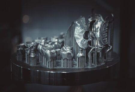 Object printed on metal 3d printer close-up. Object printed in laser sintering machine. Modern 3D printer printed from metal powder. Concept progressive additive DMLS, SLM, SLS 3d printing technologyの写真素材