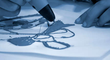 Drawing 3d pen close-up on white paperの写真素材