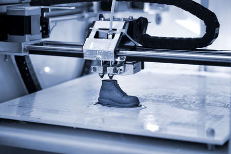 3D printer prints the form of molten plastic blue close-up.の写真素材