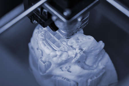 3D printer prints the form of molten plastic white.