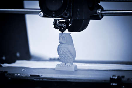 Modern 3D printer printing figure close-up. Copy space.