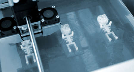 3D printer working and creating an object from the hot molten plastic