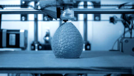 Work 3d printer close. Printing 3D printer object plastic On blue background.の写真素材