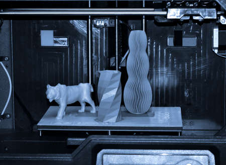 The objects printed 3D printer on a blue and black backgroundの写真素材