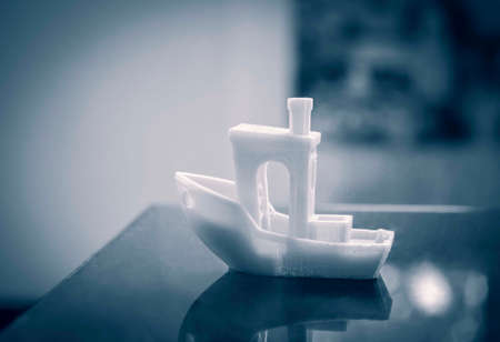 Model printed by 3d printer on a blue background close-up.