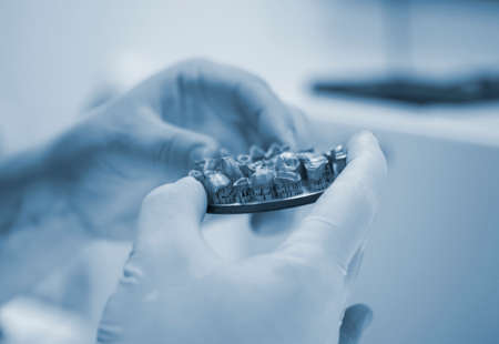 Man holds in hands object printed on metal 3d printer in laboratory.の写真素材