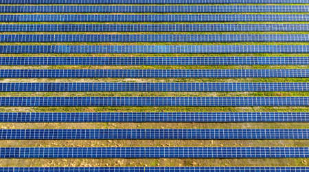 Aerial drone view flight over solar power station panels.
