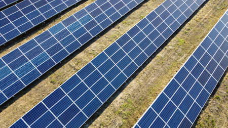 Aerial drone view flight over solar power station panels.