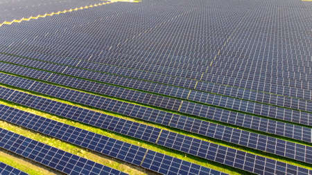Aerial drone view flight over solar power station panels.