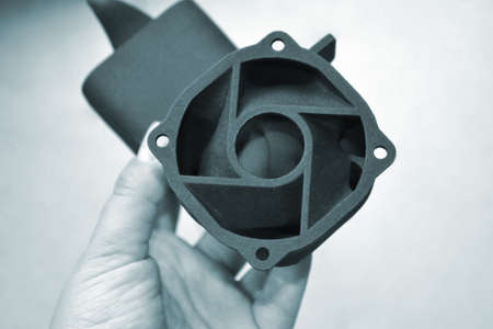 Person holding object printed on 3D printer from polyamide powderの写真素材