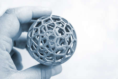 Person holding object printed on industrial powder 3D printerの写真素材
