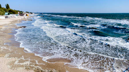 Aerial drone view flight over sea waves that roll onto sandy shore.の写真素材