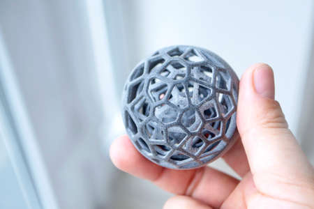Man holding model printed on 3Dprinter. Creating model on industrial 3D printerの写真素材