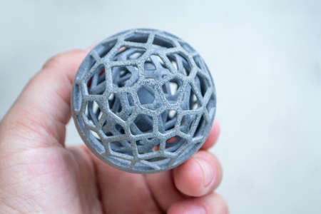 Man holding plastic model printed on powder 3d printer from polyamide powderの写真素材