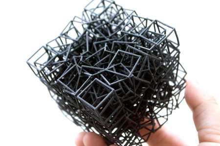Man holding plastic model printed on powder 3d printer from polyamide powder.の写真素材