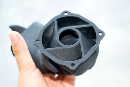 Man holding plastic model printed on powder 3d printer from polyamide powder. Multi Jet Fusion MJF.の写真素材
