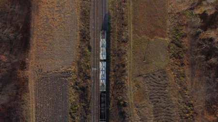 Locomotive pulls railway freight train with wagons filled coal Top View of trainの写真素材