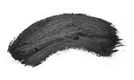 Black brush strokes oil paints on white paper. Isolated on white background.の写真素材