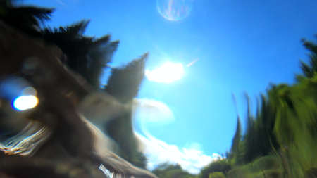 Abstract moving blurred background. Flowing water of mountain river belowの写真素材
