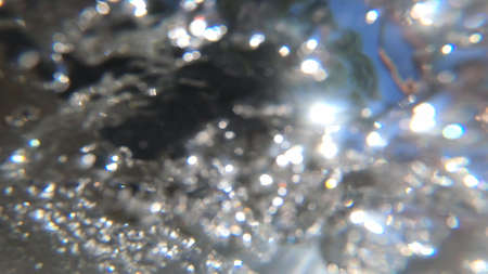Abstract moving blurred background. Flowing water of mountain river belowの写真素材