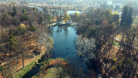 Arial drone view flight over lake in park on sunny autumn dayの写真素材