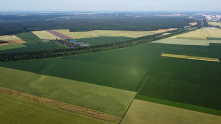Aerial drone view flight over different agricultural fieldsの写真素材