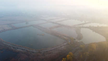 Aerial Drone View Flight Over artificially dug ponds for fish farming autumnの写真素材