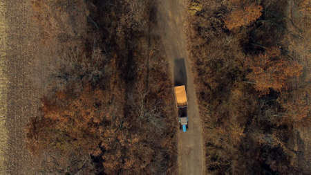 Aerial Drone View Flight Over Blue Tractor With Trailer Filled Yellow Corn Grain