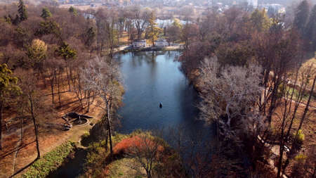 Arial drone view flight over lake in park on sunny autumn dayの写真素材