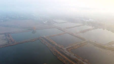 Aerial Drone View Flight Over artificially dug ponds for fish farming autumnの写真素材