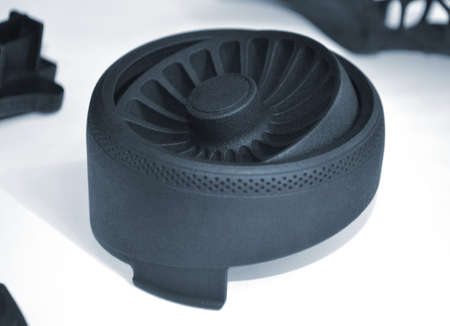 Black detail printed on 3d printer from powder on white backgroundの写真素材