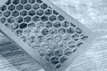 Gray object printed on powder 3D printer. Multi Jet Fusion MJF. Powder 3D printer printed three-dimensional models from polyamide powder. New modern additive 3D printing technology. Symbol innovativeの写真素材