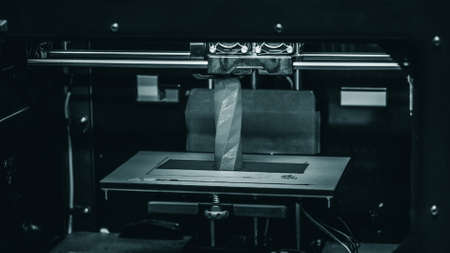 3D printer works and creates an object from the hot plasticの写真素材
