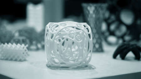 Abstract object of a blue color printed on a 3d printer on a white tableの写真素材