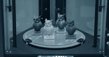 Several small objects in the form of owls stand on the working surfaceの写真素材
