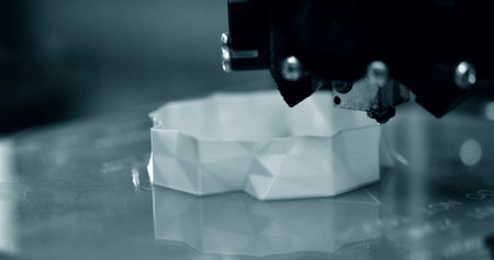 3d printer while printing a blue object close-up.の写真素材