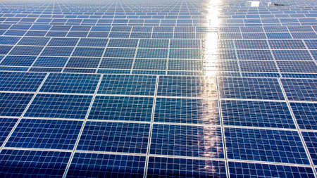 Aerial drone view flight over solar panels on sunny day close-up. Photovoltaicの写真素材