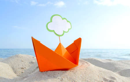 Orange Paper Boat on Sandy Seashore Close-up Small Boat from Paper on Background